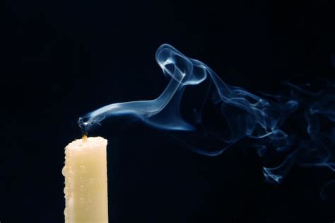 Premium Photo Smoke From An Extinguished Candle On A Dark Background