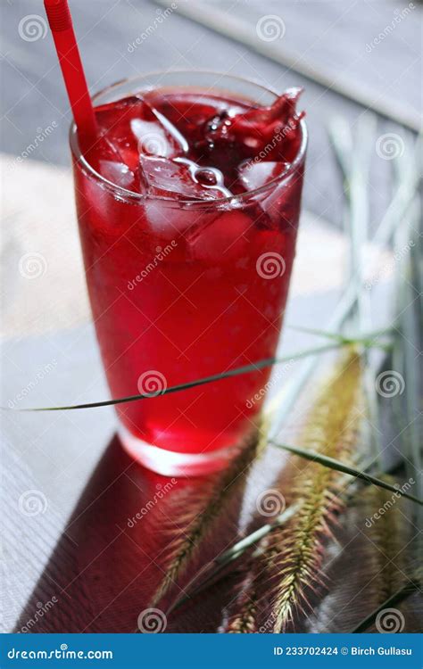 Roselle Juice In A Glass Placed On A White Table Stock Photo Image