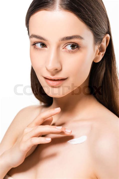 Beautiful Naked Woman With Perfect Skin Applying Cosmetic Cream On Skin And Looking Away
