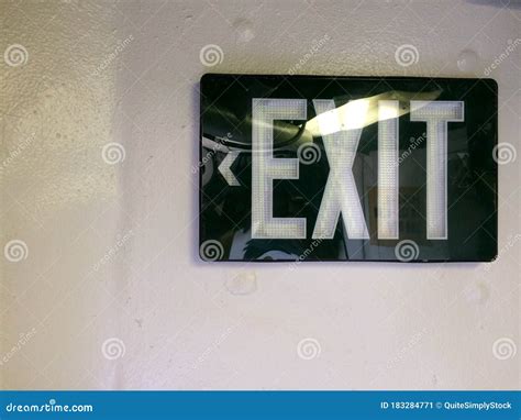 Black Exit Sign At Emergency Exit Door Background Royalty Free Stock