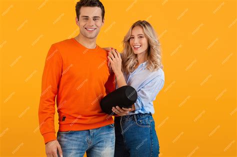 Premium Photo Beautiful Smiling Young Couple Holding Wireless Speaker