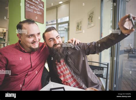 Gay Couple Taking Selfie In Cafe Stock Photo Alamy