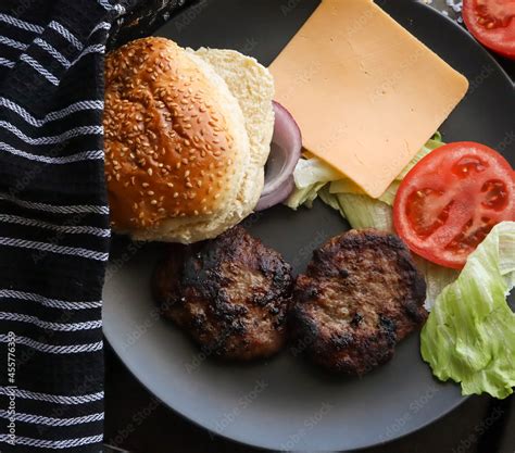 Chargrilled Beef Burgers With Lettuce Tomato Cheese And Onion On A