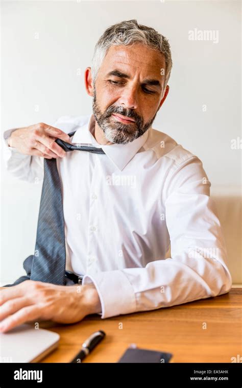 Businessman Loosening His Tie Stock Photo Alamy