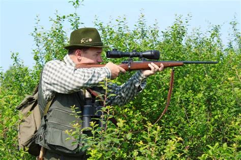 Hunter shooting with rifle gun — Stock Photo © kalinovsky #6768513