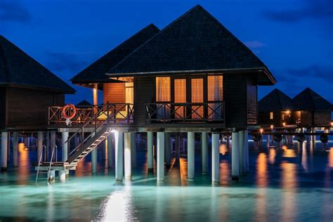 Premium Photo | Luxury water villa sunset in maldives