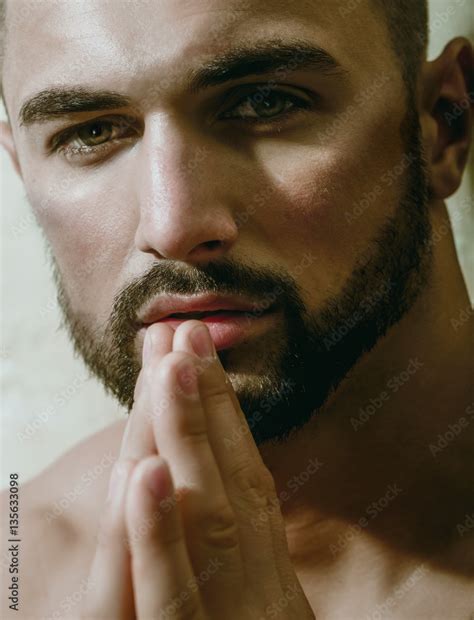 Sexy Man Praying And Looking Into Camera Portrait Of Handsome Bearded