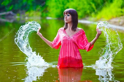 Brunette Woman Red Dress Is Wet To Waist In Splash Water Touches Stock Photo Maxximmm