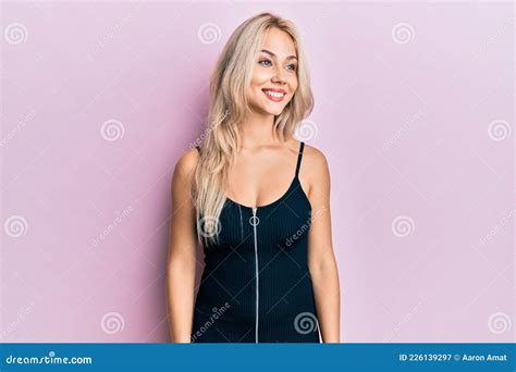 Beautiful Caucasian Blonde Girl Wearing Party Dress Looking Away To