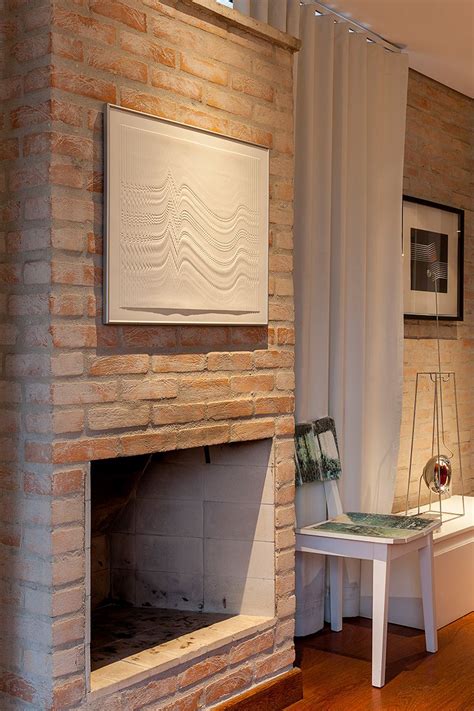 A Living Room With A Fire Place Next To A White Table And Chair In