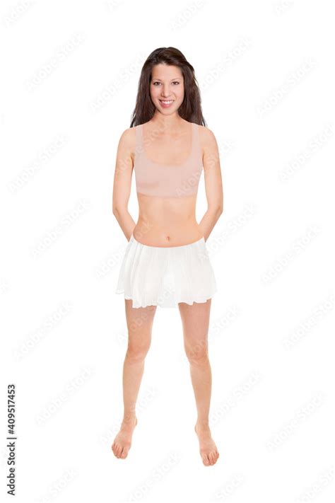 Full Length Portrait Of A Beautiful Slim Woman Wearing A White Miniskirt And A Beige Bikini Top