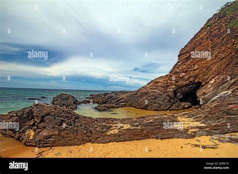 Golden Sand Beach With Rocky Outcrops At Pantai Teluk Bidara Beach In