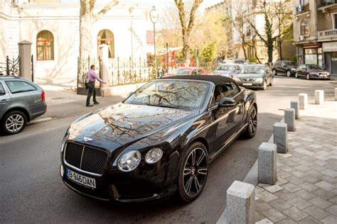 Bentley Continental Gt Convertible Parked On Street Front View