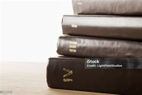 Volumes Of Old Books In Leather Brown Covers On Wooden Table Isolated