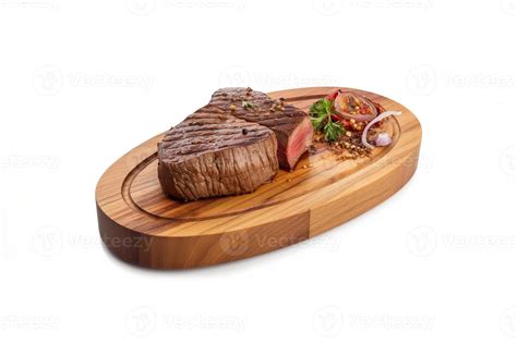 A Wooden Plate Of Beef Steak Grilled With Sauce Isolated On White