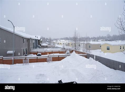 Snow-covered landscape featuring mobile homes in a trailer park ...