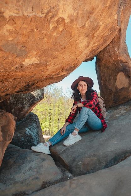 Premium Photo Happy Woman Hiker Sitting At The Rock