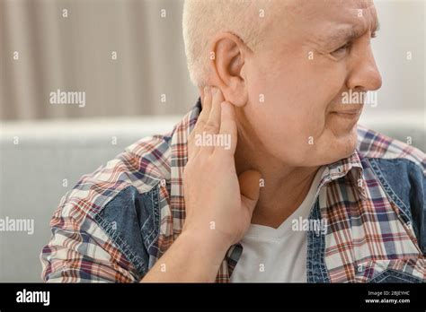 Mature Man Suffering From Pain At Home Stock Photo Alamy