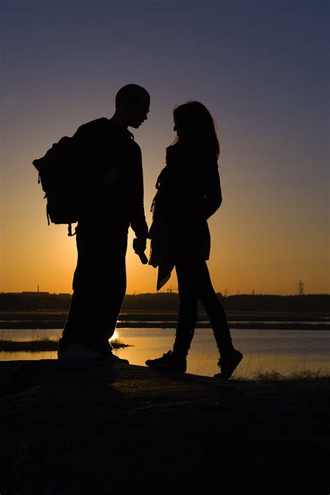 Royalty Free Photo Man And Woman Standing In Front Of Each Other Near Body Of Water In