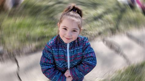 Premium Photo Portrait Of Cute Smiling Girl Standing Outdoors