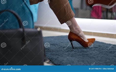 Unrecognizable Caucasian Gay Man Sitting On Armchair In Shop Putting Down Leather Purse Crossing