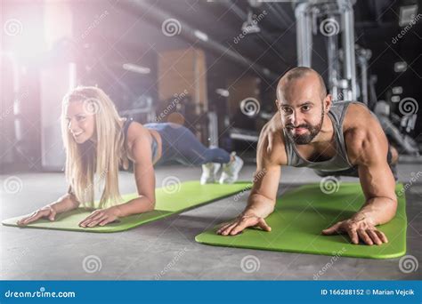 Sport Couple Doing Plank Exercise Workout In Fitness Centrum Man And Woman Practicing Plank In