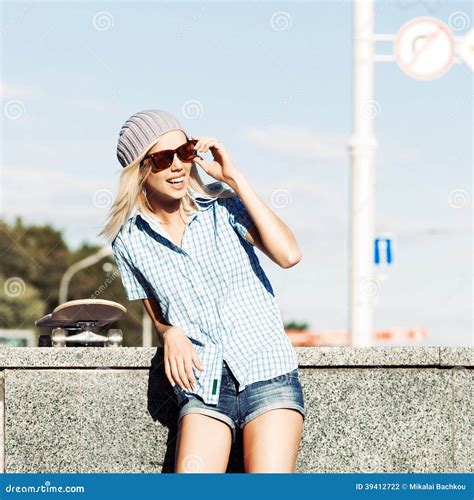Beautiful Blonde Girl In Short Shorts With Skateboard Stock Photo