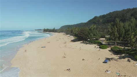 Aerial view of tourists on the Banzai Pipeline beach on North Shore of ...