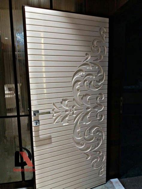 A White Door With An Intricate Design On The Side And Glass Doors To