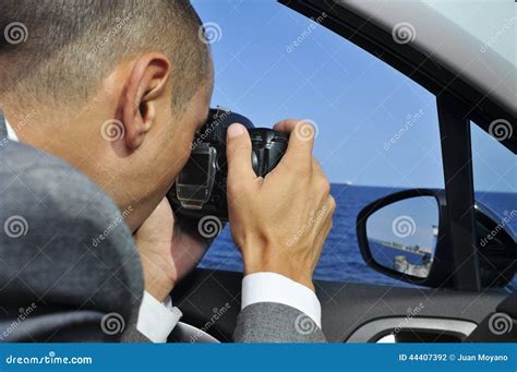 Detective Or A Paparazzi Taking Photos From Inside A Car Stock Photo