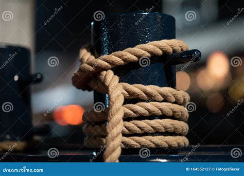 Mooring Bollard Intertwined With Mooring Rope At The Port Stock Image