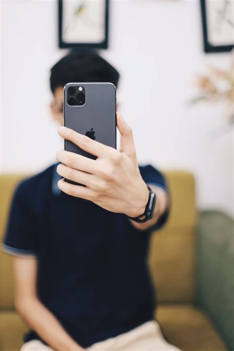 Man Holding Iphone 11 Photo Free Iphone Image On Unsplash