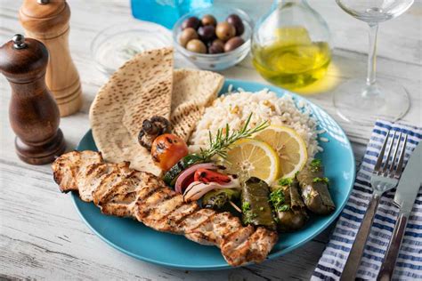 assorted greek food platter with souvlaki, rice, pita and dolmades | Jaime Davis Schick