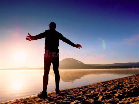 Man Exercising On Beach Silhouette Of Active Man Exercising And