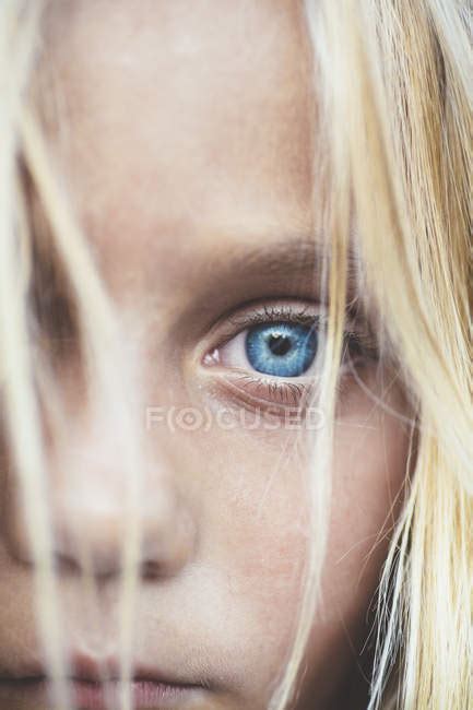 Close Up Shot Of Beautiful Blonde Preteen Girl Partial View Of Blue