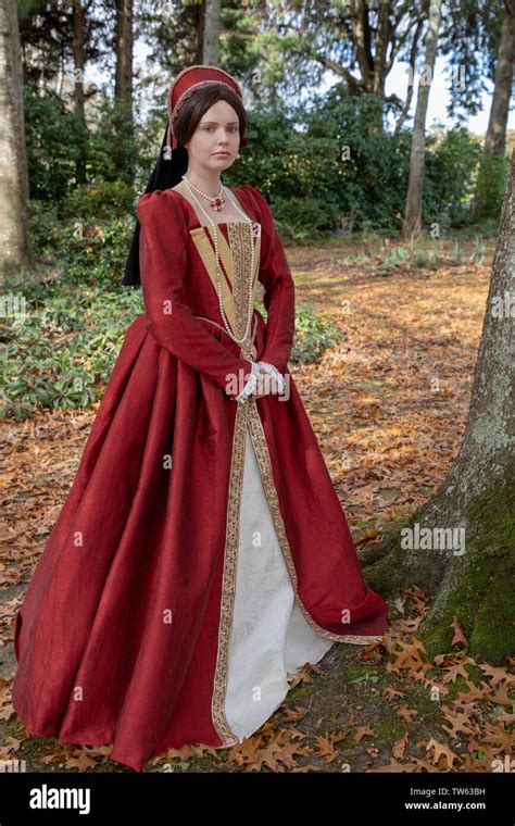 Tudor Woman In Red Dress Walking In Garden Stock Photo Alamy