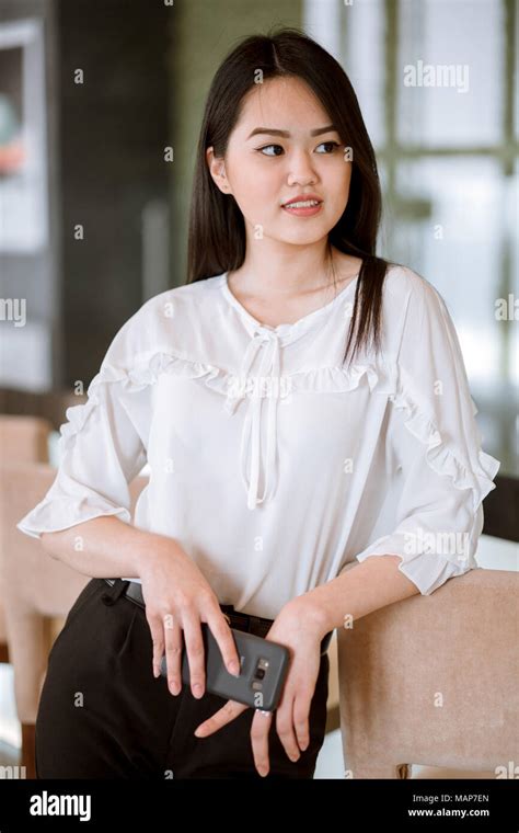 Asian Woman With Black Long Straight Black Hair Wearing White Blouse