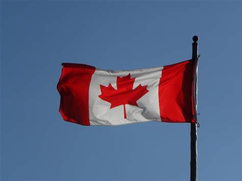 Premium Ai Image A Red And White Flag With A Maple Leaf On It