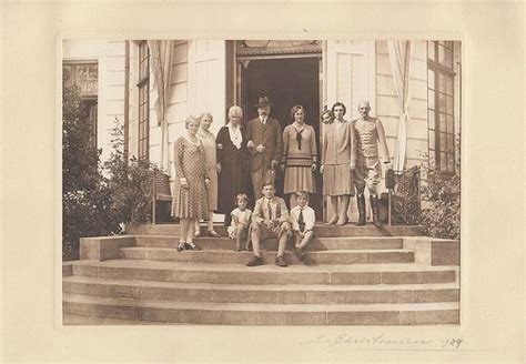 An Old Black And White Photo Of People Standing On Steps