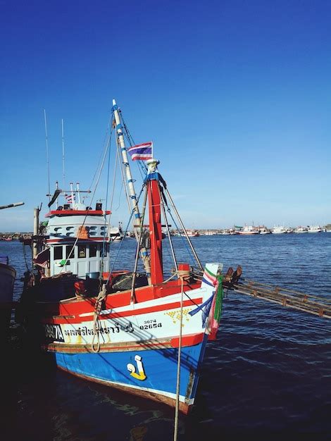 Premium Photo Ship Moored On Sea Against Clear Blue Sky