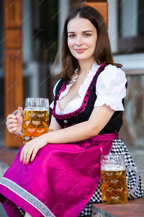 Premium Photo Sexy Russian Woman In Bavarian Dress Holding Beer Mugs