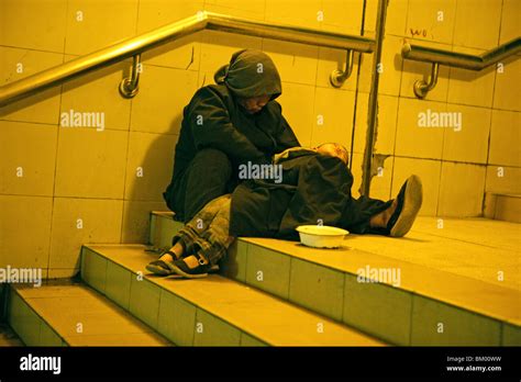 Beggar with young child, Metro Stock Photo - Alamy