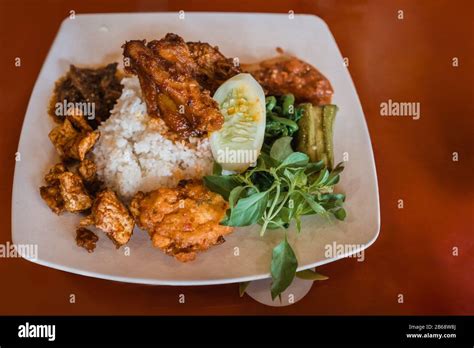 Authentic Indonesian Food Nasi Rames With Chicken Rendang Stock Photo