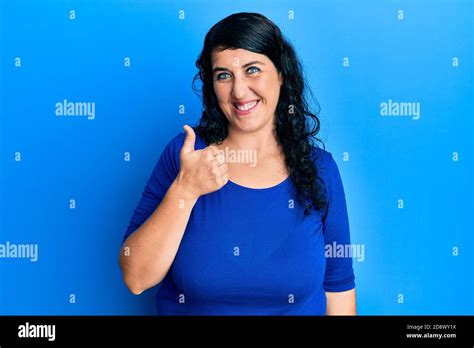 Plus Size Brunette Woman Wearing Casual Blue Shirt Doing Happy Thumbs Up Gesture With Hand