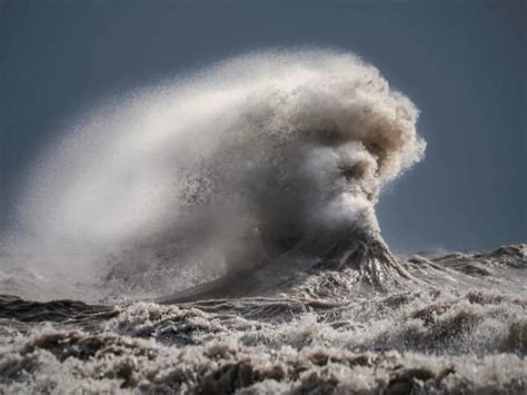 strong winds create  crashing wave     face