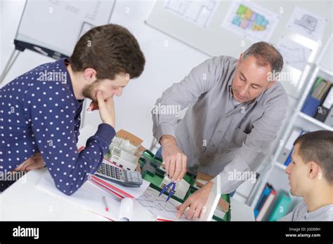 teacher helps students of math class Stock Photo - Alamy