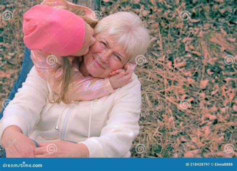 Loving Cute Granddaughter Kissing Her Grandmother Having Good Times