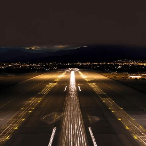 Premium Photo | Arafly lit airport runway at night with lights on the runway generative ai