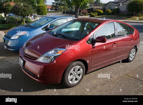 A side view of two parked Toyota Prius hybrid cars. Cupertino ...