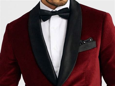 A Man In A Tuxedo Is Wearing A Black Bow Tie And Red Jacket